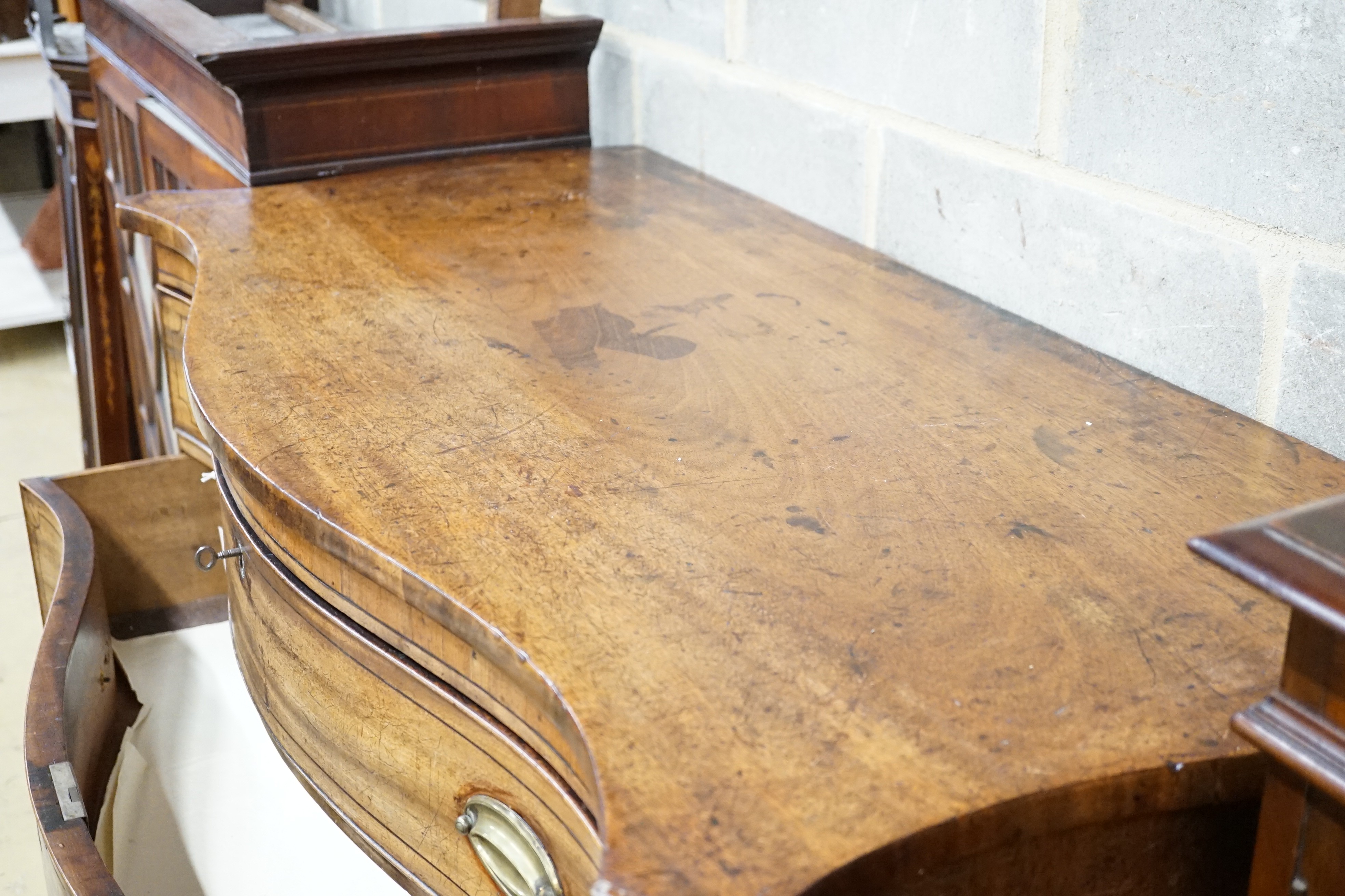 A George III mahogany serpentine chest with ebony stringing and four graduated long drawers, the top drawer divided into three, width 120cm, height 104cm, depth 59cm